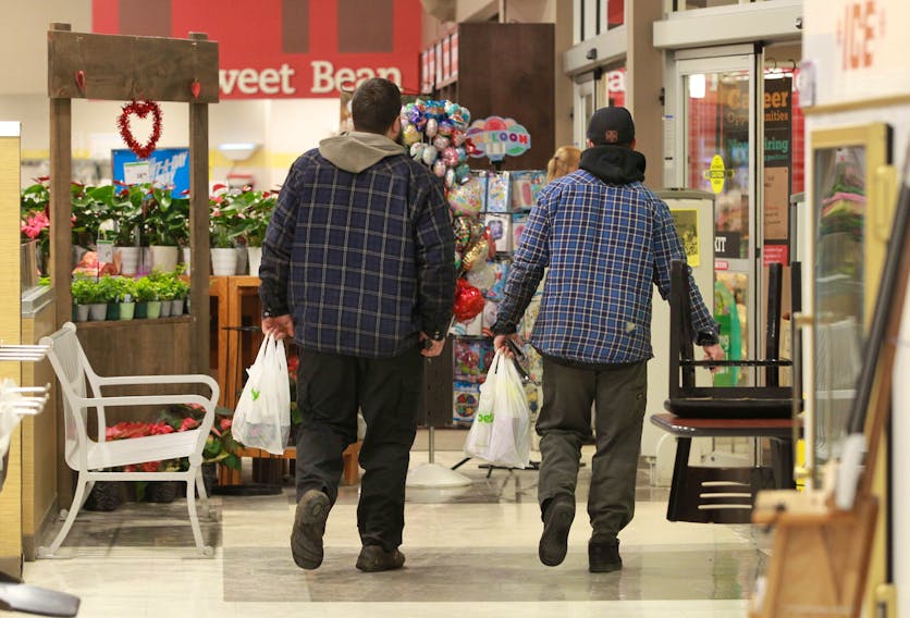 Customers walk away with a bag of groceries each, after their purchase at the Windsor Street Sobeys on Thursday, Jan. 17, 2020.