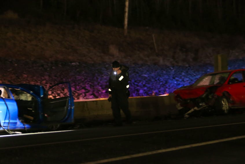 FOR NEWS STANDALONE:
A Halifax regional police officer examines the scene of a 2 vehicle accident on Highway 11, near Exit 8 in Dartmouth Saturday February 7, 2021. STILL AWAITING RELEASE....IT APPEARS RED VEHICLE TRAVELED IN WRONG LANE.

TIM KROCHAK PHOTO