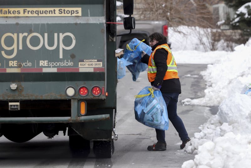 A worker picks up bags of recycling in St. Margaret's Bay Road area neighborhood in Halifax Friday, Feb. 12, 2021. - Tim Krochak