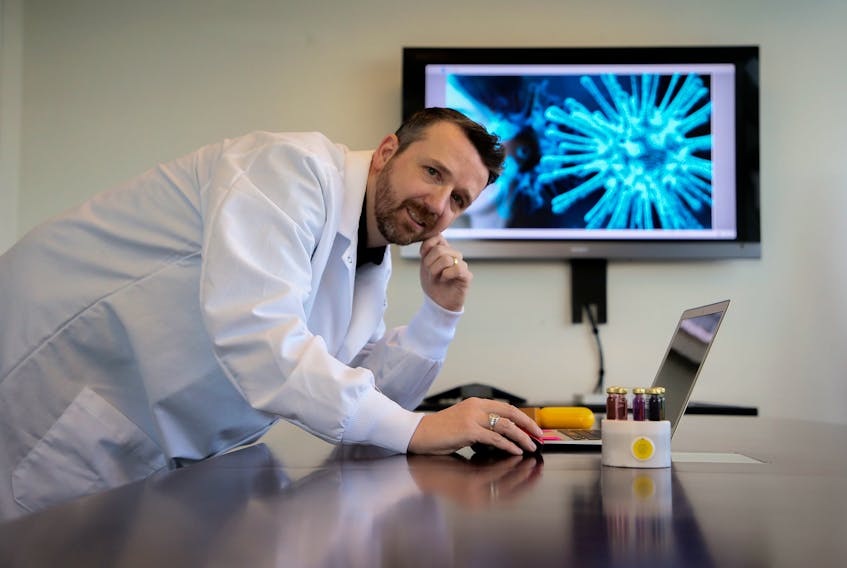 Sona Nanotech Inc. CEO Darren Rowles., is seen with tubes with some of their gold nanorod technology at their office in Halifax Friday. The company is developing a quick test that will screen for the coronavirus. The Chronicle Herald