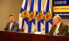 FOR NEWS STORY:
Nova Scotia's new Premier, Iain Rankin, smiles as the province's chief medical officer, 
Dr. Robert Strang welcomes him to his first COVID-19 news conference, in Halifax Wednesday February 24, 2021.

TIM KROCHAK PHOTO