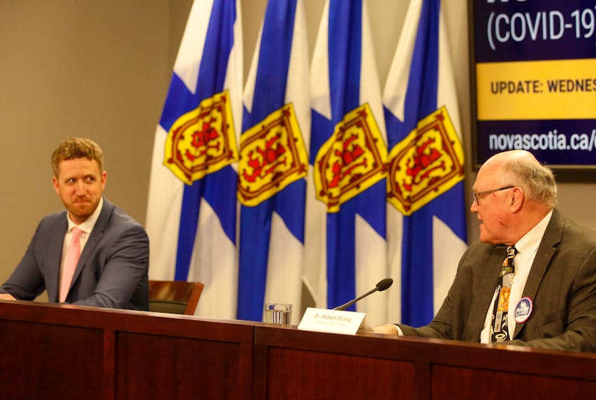 FOR NEWS STORY:
Nova Scotia's new Premier, Iain Rankin, smiles as the province's chief medical officer, 
Dr. Robert Strang welcomes him to his first COVID-19 news conference, in Halifax Wednesday February 24, 2021.

TIM KROCHAK PHOTO