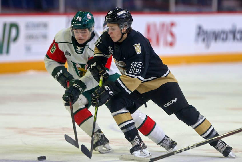 Halifax Mooseheads Liam Peyton tries to steal the puck from Charlottetown Islanders Patrick Guay during QMJHL action in Halifax Sunday March 14, 2021.

TIM KROCHAK PHOTO