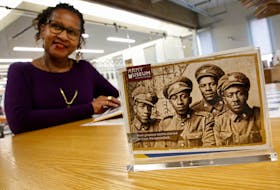 FOR PEDDLE STORY:
Sylvia Parris-Drummond is seen with a photo of the No. 2 Construction Battalion, one of the four men is her father, Joseph A. Parris, second from left...seen in her office in Halifax Friday March 26, 2021. On Saturday the federal government is going to apologize for the racism experienced by the Battalion, a unit made up of black men.....

TIM KROCHAK PHOTO