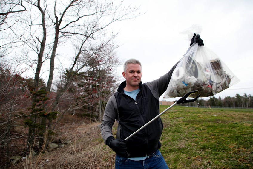Adam Ullock, the creator of the Nova Scotia ONE Garbage Bag Challenge, displays some of the garbage he collected shortly after meeting up with the photographer, in Halifax Tuesday May 5, 2020. Ullock, is challenging folks to pick up litter.