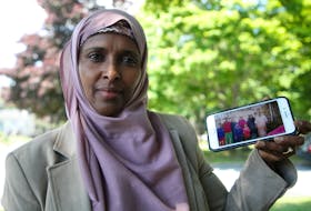 Nasra Gele, a woman of Somali descent who has been living in Halifax since 1997, is working with a private sponsorship group, United We Win Halifax, to sponsor her brother, his wife, and their seven children and bring them to Canada. They have been living in a refugee camp in Kenya for over 20 years. Nasra is seen with a photograph of her brother and his family, in Halifax Friday July 10, 2020.