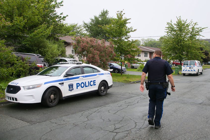 FOR NEWS STORY:
A Halifax regional police officer surveys the street following an incident on Renfrew Street in Dartmouth  Sunday July 12, 2020.  One person was taken to hospital. FROM POLICE RELEASE:
"At approximately 8:20 a.m. Halifax Regional Police patrol members responded to a report of a male who had been stabbed on the roadway on Renfrew Street in Dartmouth.  Officers located an 18-year-old male suffering from a stab wound. The male was transported to the hospital with serious injuries"

TIM KROCHAK/ The Chronicle Herald