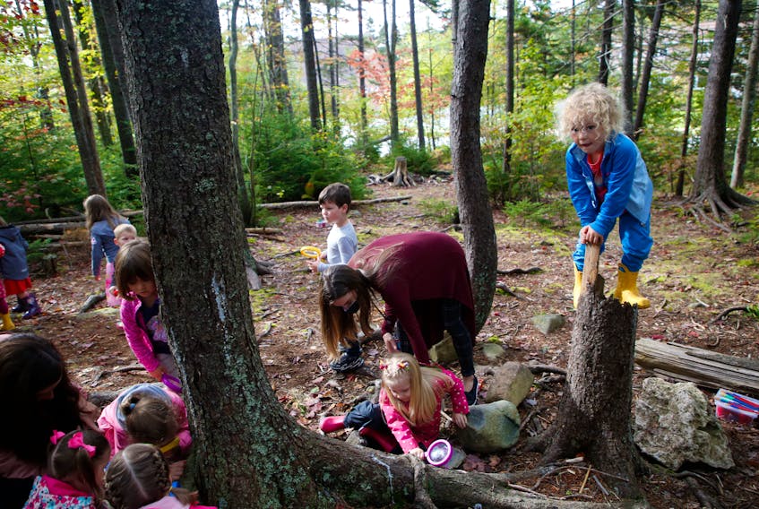 Youngsters and their teachers explore in a wooded area near Colby Village Elementary School Friday, Oct. 2, 2020. Premier Stephen McNeil announced the completion of the implementation of the Nova Scotia pre-primary program in the playground at the school.