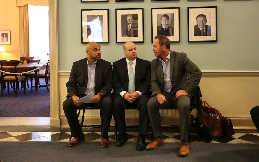 From left, Shane Russell, vice -president of the crown attorney's association (NSCAA), Perry Borden, President of the NSCAA and Rick Woodburn, a lead negotiator, commiserate before their news conference at Province House on Tuesday. The NSCAA announced that beginning in the morning of October 23rd, it will be withdrawing crown attorney services as a job action to counter the province's passing of Bill 203 that they say guts their existing collective agreement.