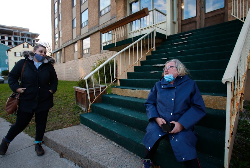 FOR LAMBIE STORY:
A passer-by stops to give Grace Fogarty, right, some encouragement as she sits outside her Dutch Village Road apartment building in Halifax Wednesday October 28, 2020. She recently received a $650 rent increase and the woman had seen Fogarty's plight on a social media post and said how angry at how a building owner could just do that.

TIM KROCHAK PHOTO