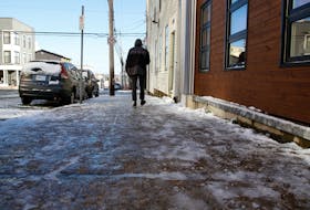 A man walks along an icy sidewalk on Cornwallis Street in Halifax Wednesday, Nov. 4, 2020.