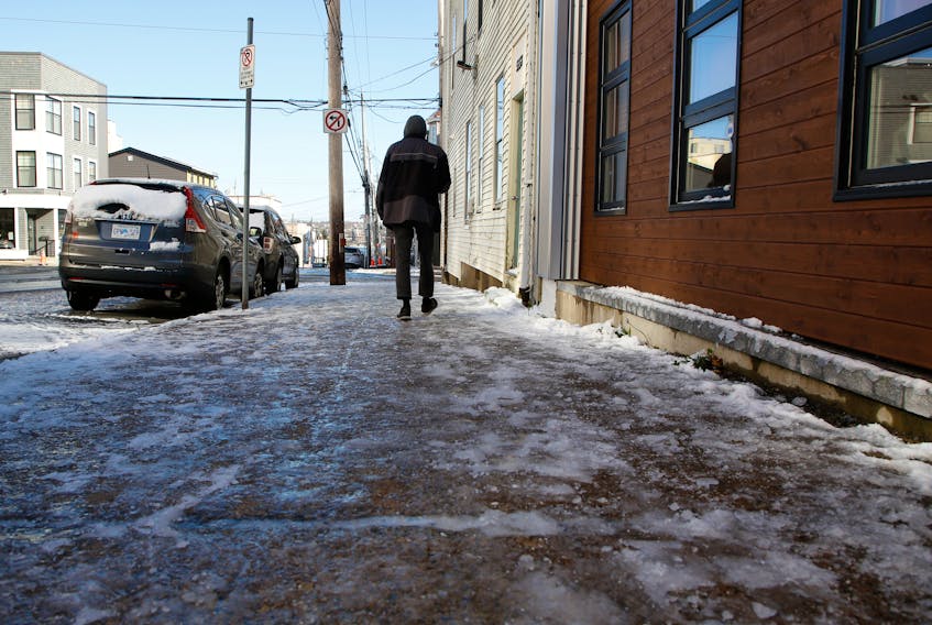 A man walks along an icy sidewalk on Cornwallis Street in Halifax Wednesday, Nov. 4, 2020.