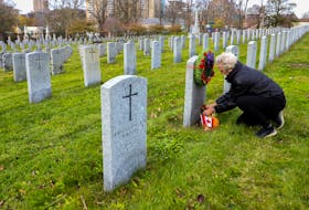 FOR NEWS STANDALONE:
Sandra Doherty arranges flowers near the headstone of her father, the late veteran, Sgt Major Leo Gargan, at Fort Massey Cemetery in Halifax Friday November 6, 2020. 
Doherty said they were a military family, with 9 members having served.

TIM KROCHAK PHOTO