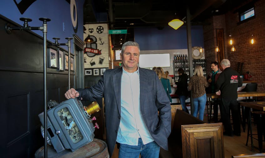 Brian Titus, co-founder and president of Garrison Brewing, shows off an old Century movie projector once used at the Oxford Theatre during a sneak peek of the brewery's new taproom, the Oxford, in Halifax on Thursday. TIM KROCHAK - The Chronicle Herald