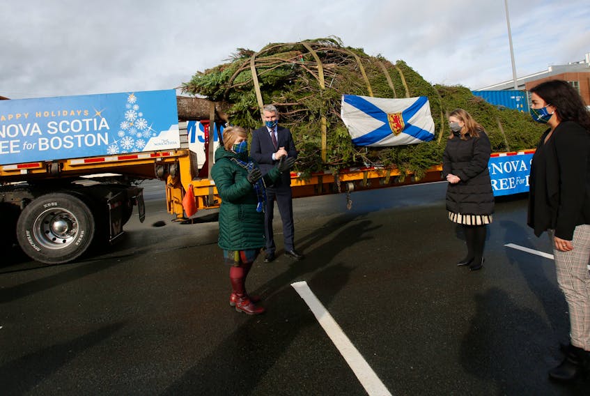 Communities, Culture and Heritage Minister Suzanne Lohnes-Croft, Premier Stephen McNeil,  U.S. Consul Andrea Wiktowy and Thordis Thorlacius, liner manager, Eimskip Canada, talk next to this year's Christmas tree that is headed to Boston, in Halifax on Monday November 16, 2020.