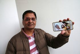 Gaurav Sadh, displays a family photo of himself, his wife Sakshi, daughter Krisha and son, Vivaan, taken last October, and seen in Halifax Friday, Nov. 20, 2020. His family has been left stranded in India since March due to the COVID-19 pandemic.