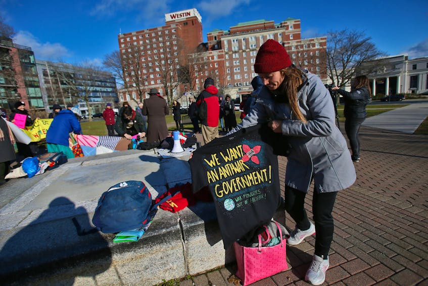 FOR PEDDLE STORY:
Melanie Oakley displays one of the t-shirts she had made that she was putting up for donations, for the No Harbour For War, as they gather for a demonstration in Cornwallis Park in Halifax Saturday, November 23, 2019. They were voicing their disagreement with the Halifax International Security Forum which is being held across the street at the Westin Hotel.

TIM KROCHAK/ The Chronicle Herald