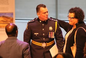 Halifax Regional Police Chief Dan Kinsella is congratulated by Natalie Borden, chairwoman of the Halifax police commission, after apologizing for his department's street check policy, during a public event at the Halifax Central Library on Friday, Nov. 29, 2019.