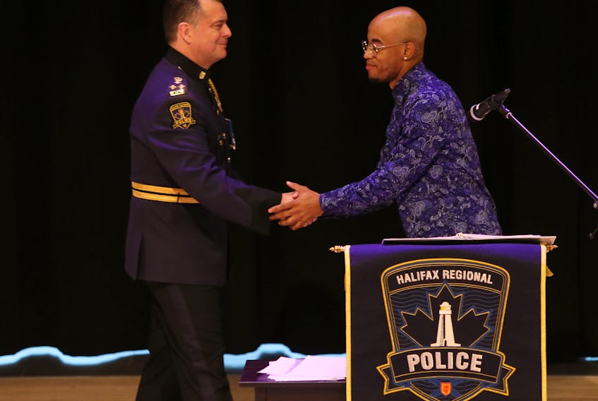 Halifax Regional Police Chief Dan Kinsella shakes hands with Quentrel Provo after the chief apologized for his department's street check policy during a public event at the Halifax Central Library on Friday, Nov. 29, 2019.