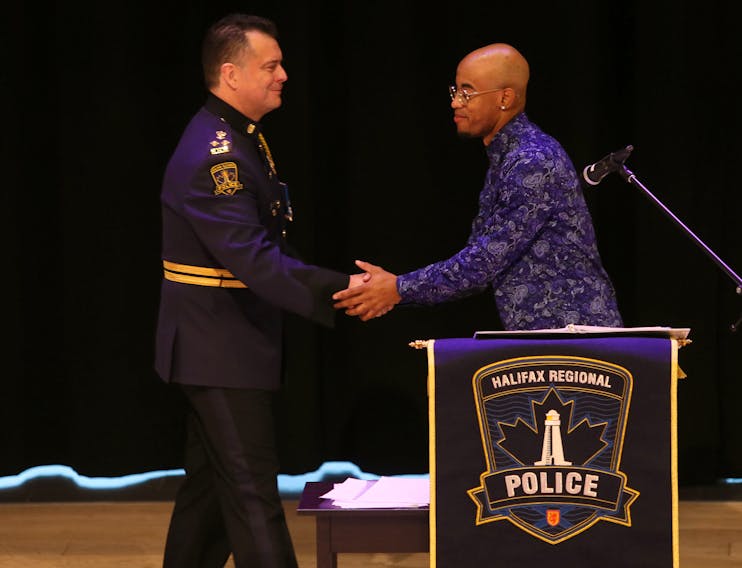 Halifax Regional Police Chief Dan Kinsella shakes hands with Quentrel Provo after the chief apologized for his department's street check policy during a public event at the Halifax Central Library on Friday, Nov. 29, 2019.