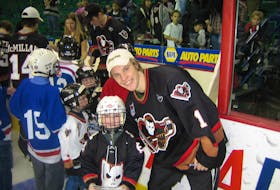Five-year-old Taylor Gauthier poses with then-Calgary Hitmen goaltender Justin Pogge in 2006. Gauthier dressed up as Pogge for Halloween that year and was inspired by his hockey idol to dream about one day playing in goal for Canada.
