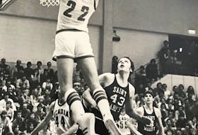 Ted Upshaw of the Acadia Axemen goes up for a dunk against the Saint Mary's Huskies at War Memorial Gymnasium in Wolfville. (CONTRIBUTED)