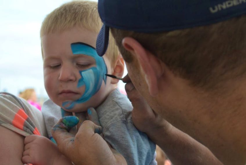 Jaxon Fleming, 2, gets his face painted at the Labour Day Family Fun Picnic on Monday.