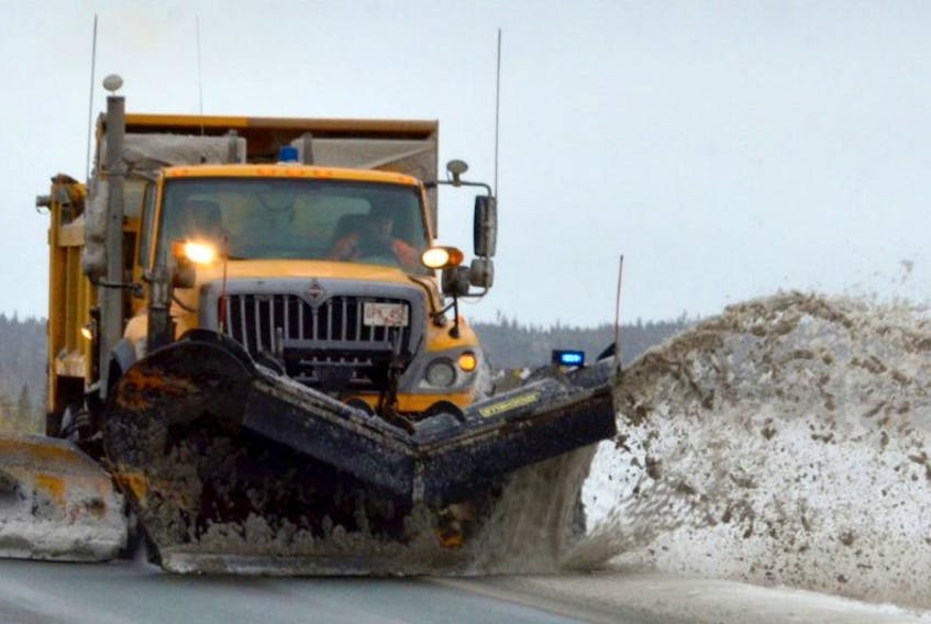 A Transportation and Works  truck plows and lays down salt on the Outer Ring Road in a November 2011 photo.