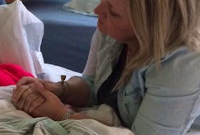 Jennifer Hillier-Penney holds her mother’s hand in hospital. Jennifer was described as kind, caring and mothering.