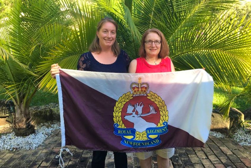 Heather Rowsell (left) and her mother Kerri Rowsell hold the Royal Newfoundland Regiment flag they will use as a banner as they represent the regiment in Sydney, Australia’s ANZAC Day march Tuesday.
