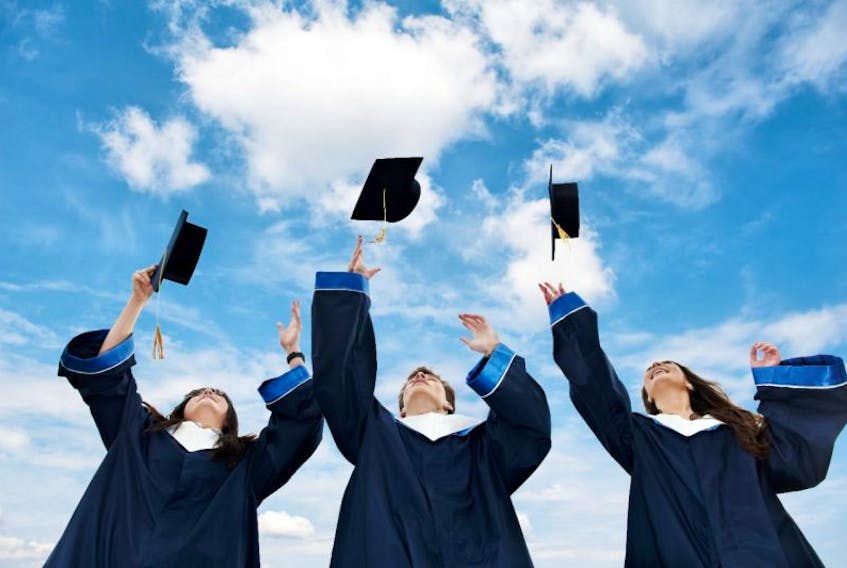 Three graduate students toss their hats into a blue sky. Many high school students in Newfoundland and Labrador have mixed feelings about the direction they will take after graduating. 