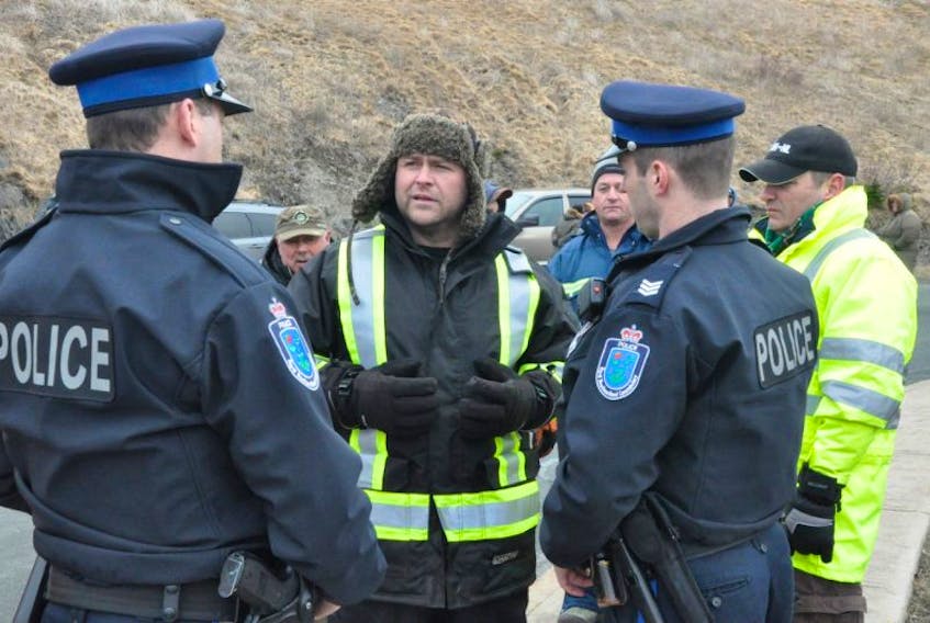 While the nearly two-dozen supporters who joined Richard Gillett (centre) at the road leading to the NAFC building Thursday morning were peaceful, Royal Newfoundland Constabulary patrol division officers were still called to the scene to assess the situation.