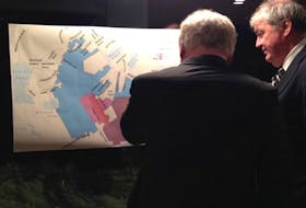 Neil Dawe of Tract Consulting looks at a plan offered for comment at a public meeting in Portugal Cove-St. Philip’s on Jan. 18.