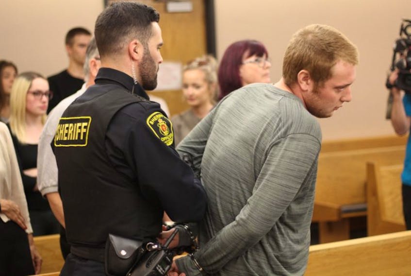 Joshua Steele-Young is taken back into custody during a break in his bail hearing in provincial court Monday. Steele-Young, charged with dangerous driving causing bodily harm and forcible confinement in connection with a March 20 crash that left his passenger paralyzed, is accused of breaching conditions of his original release. He was granted bail with a number of strict conditions.