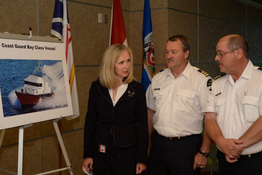 Pictured beside a Canadian Coast Guard photo of what the Conception Bay will look like is coast guard assistant commissioner Jane Kelsey, CCG Supt. Barry Witherall, and Wade Stagg, acting regional director of fleets, all with the CCG Atlantic Region and based out of the CCG headquarters on Southside Road in St. John’s.