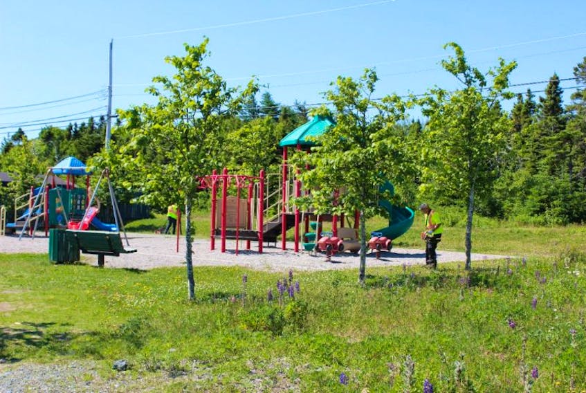 City of St. John’s employees complete caretaking tasks at the Penney Crescent Playground Monday. The playground would be moved as part of a proposed development project. A public meeting on a required zoning change for the project is set for Aug. 8.