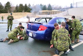 Master Cpl. Garrett McDougall of 35 Field Ambulance Unit (left) takes notes on the response of members of CFS St. John’s Station Defence Force as they participate in a mock suicide-bomber attack Thursday.