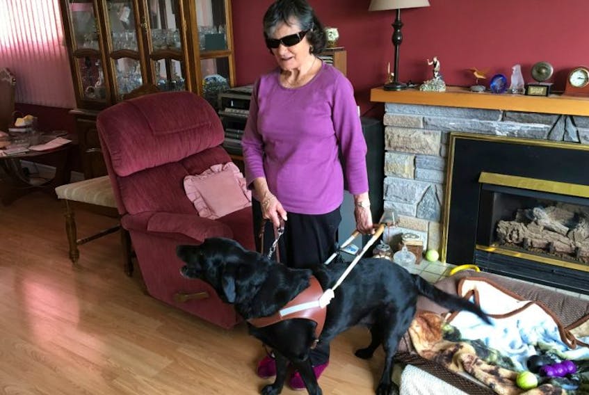 Margaret Thomson lives in the west end of St. John’s with her husband and is seen here in her home, just after harnessing her guide dog, Gianna.