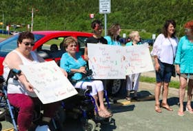 Cancer patients and supporters hold a demonstration Tuesday morning near the Dr. H. Bliss Murphy Cancer Centre. The group wants Eastern Health to designate 25 parking spaces close to the centre for cancer patients.