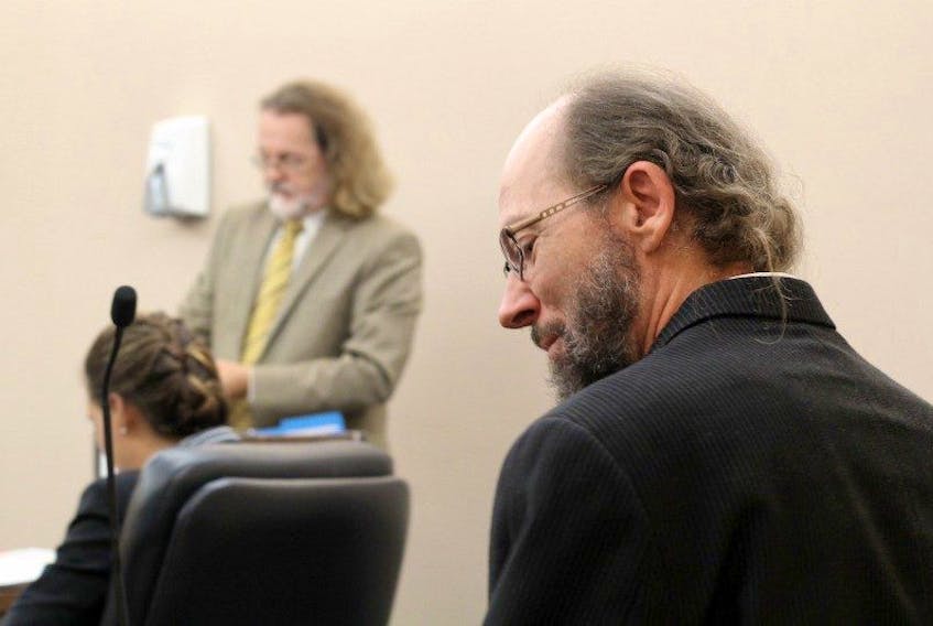 Kenneth Wayne Harrisson (right) waits for his trial to start in provincial court in St. John’s Friday morning, while his lawyers Bob Buckingham and Brittany Whalen prepare in the background. Harrisson is charged with importing and possessing child pornography in connection with an alleged child sex doll he is said to have imported from Japan.