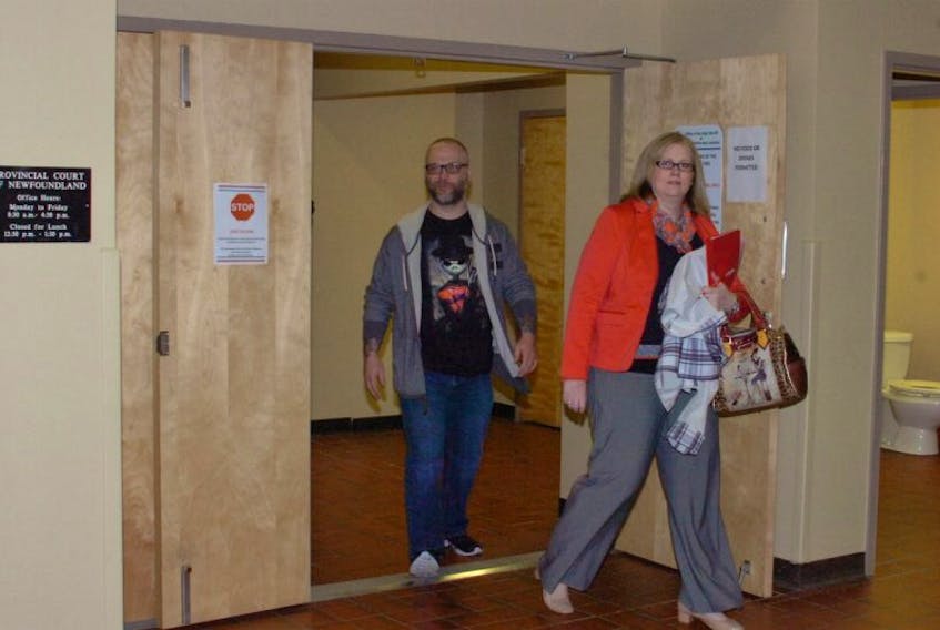 Ken Joseph Power walks out of Courtroom No. 7 at provincial court with his lawyer, Keri-Lynn Power, Thursday after his case was called before a judge.