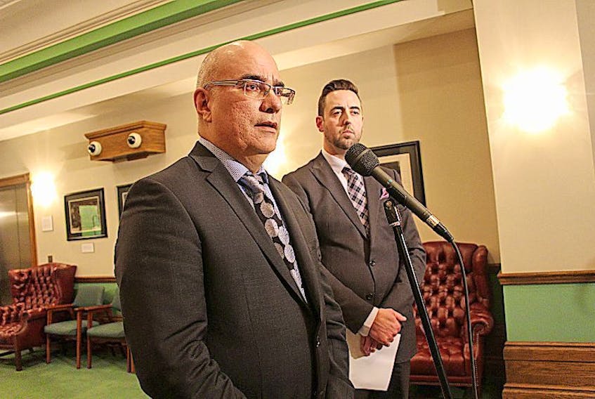 Dr. Matthew Bowes, the Chief Medical Examiner for Nova Scotia, (left) and Justice Minister Andrew Parsons are shown in August 2016 as Parsons releases the terms of reference for an external review of the Office of the Chief Medical Examiner .