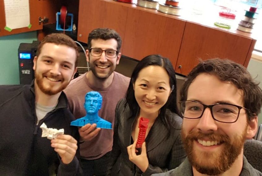 Project leaders at MUN Med 3D pose for a celebratory selfie upon meeting Dr. Julielynn Wong (second from right) of 3D4MD to discuss the potential in 3D printing locally for medical purposes — both for training and treatment. From left, Travis Pickett, Michael Bartellas and Wong hold a few items printed by MUN Med 3D, while Stephen Ryan snaps the photo.