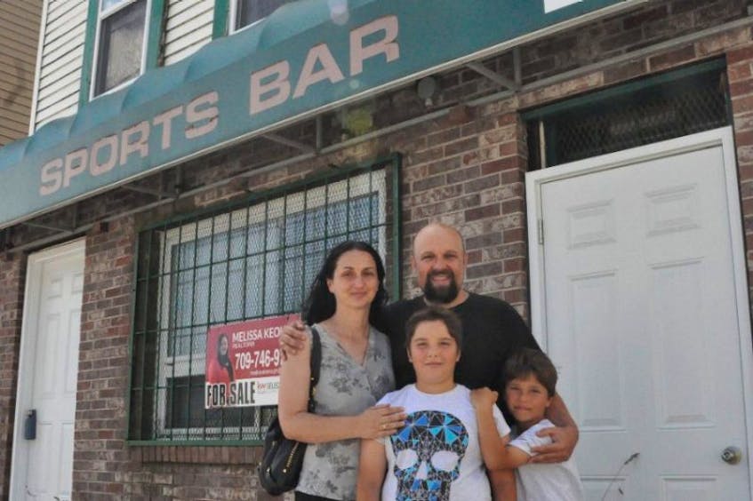 Eldin Husic (right) and his wife Adnela Halebic-Husic, shown here with their sons Mehmed-Mesha, left, and Tarik, are hopeful that St. John’s city council will vote to extend the non-conforming use expiration date on commercial properties in residential zone such that they can open the Balkan Grill on Boncloddy Street.