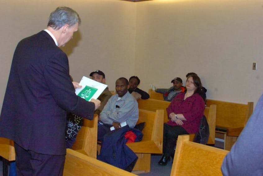 Judge David Orr speaks to a group from the Association of New Canadians about the Canadian legal system at provincial court in St. John’s Wednesday. Among the group was Syntyche Mutombo (third from left, seated).