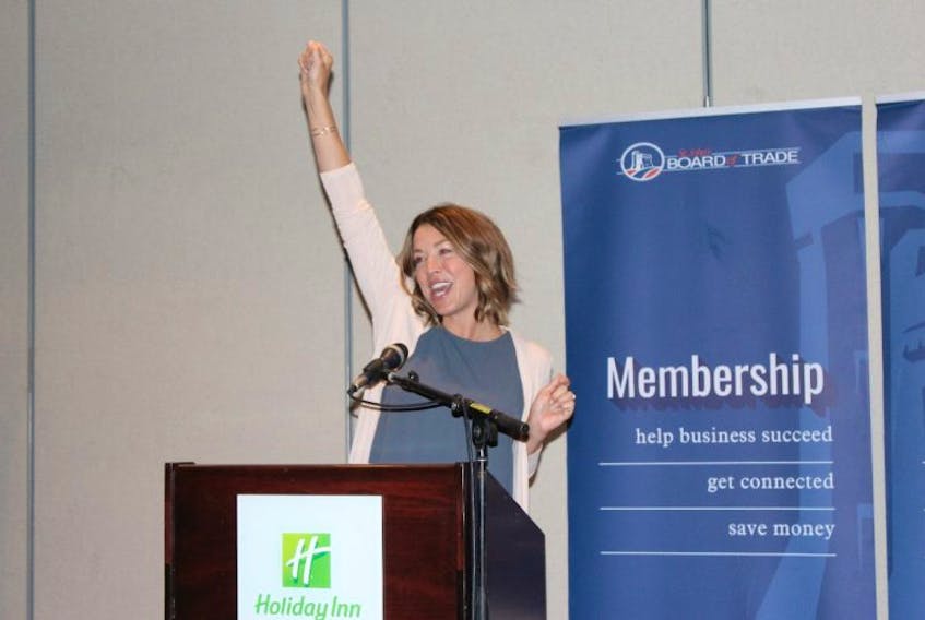 Amputee Candace Carnahan of New Brunswick leads the cheer, “If you see something, say something” during her speech about the importance of workplace health and safety at the Board of Trade luncheon at the Holiday Inn Monday afternoon.