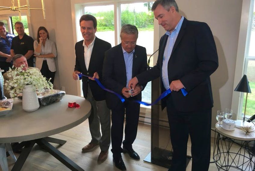 Danny Williams (centre), president and CEO of DewCor., held an official ribbon-cutting ceremony Wednesday morning to open the Galway Living residential project at the model home in Galway.