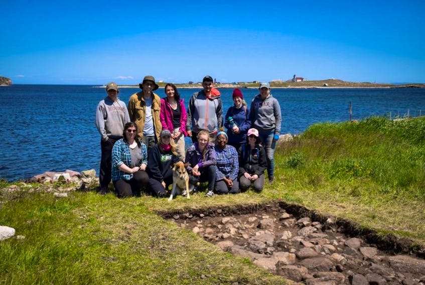 Catherine Losier’s field school team next to an excavation unit at Anse à Bertrand, St-Pierre. Île-aux-Marins can be seen in the background