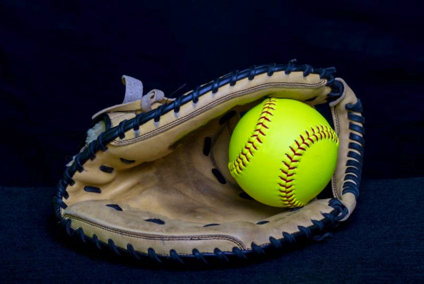 A fastpitch softball glove with a yellow ball with a black background.