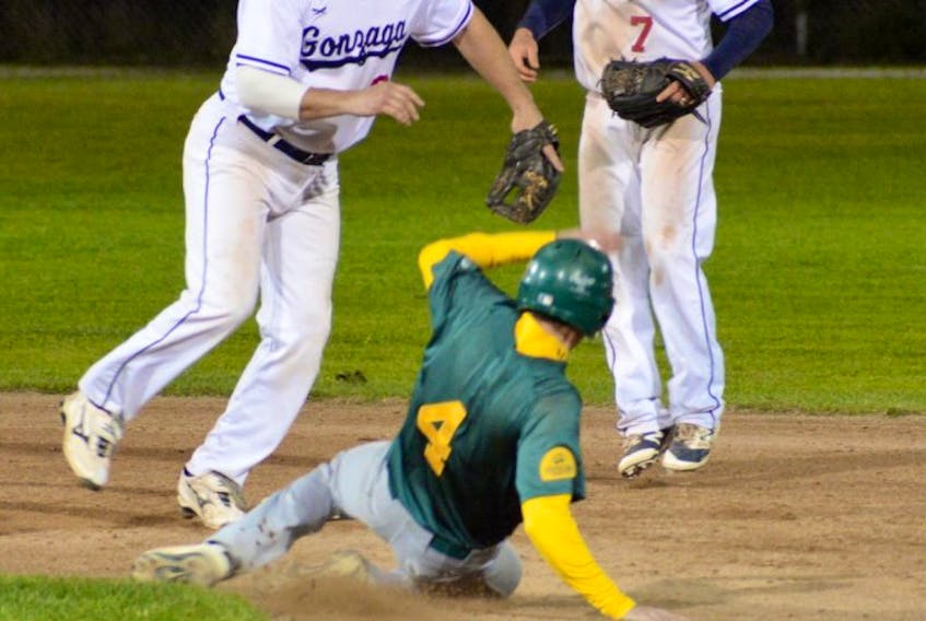 Bob Kent of Shamrocks is out at second base as RMM Gonzaga Vikings shortstop Gerald Butt completes the second half of a double play in Game 4 of the St. John’s Molson Senior Baseball League championship Tuesday night at St. Pat’s Ball Park. Looking on is Vikings second baseman Mike O’Neill.